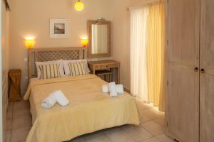 a bedroom with a bed with two towels on it at Modi Resort in Xiropigado