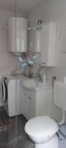 a white bathroom with a toilet and a sink at Apartment Tušek in Jadranovo +72 photos