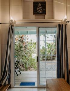 an open door in a room with a porch at CherryTree Bungalow of Villa Paraiso / Beachfront in Big Creek