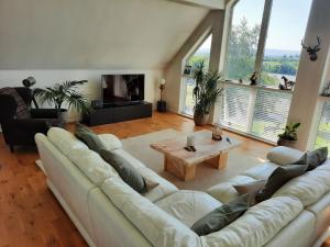 a living room with a white couch and a coffee table at Stunning 55 Riverun on the banks of the lovely Riv in Belturbet