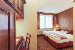 Postel nebo postele na pokoji v ubytování Le Petit CHARME-INN