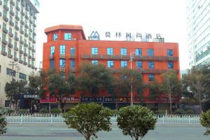 a red building with chinese writing on top of it at Morninginn, Tujiachong Metro Station in Changsha