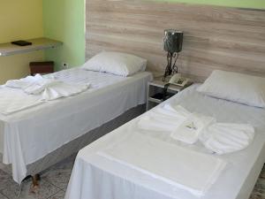 Cama ou camas em um quarto em Astúrias Praia Hotel