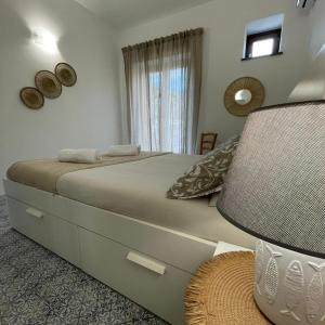 a bedroom with a large bed and a window at Casa Grazia Apartments in Lipari