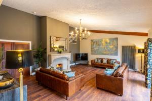 a living room with two couches and a fireplace at Corrie House with Hot Tub in Belladrum