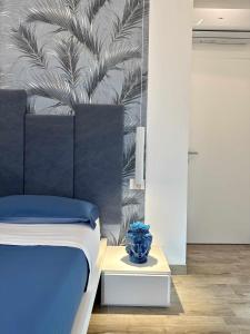 ランペドゥーザにあるBeB Altomareのベッドルーム1室(ベッド1台、テーブル上の青い花瓶1枚付)