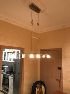a chandelier hanging from a ceiling in a kitchen at Appartement tanger Beach in Tangier