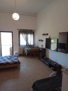 a living room with a bed and a dining room at Tzoumerka Panorama in Pramanta