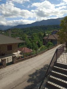 an empty road in a village with mountains in the background at Tzoumerka Panorama in Pramanta