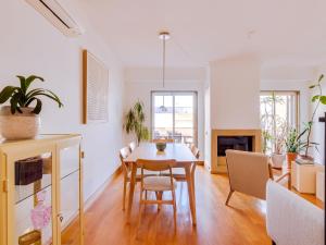 een eetkamer en een woonkamer met een tafel en stoelen bij AL - Quarteira Terrace Penthouse in Quarteira