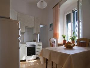 a kitchen with a table with a bowl of fruit on it at Apartment Manuela in Dubrovnik