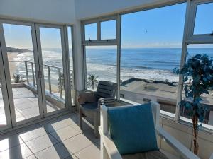 a living room with a view of the ocean at Seabrook In-house Holiday Rentals in Margate