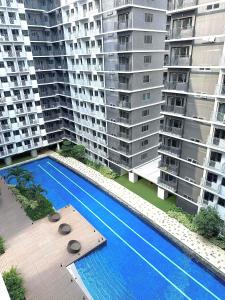 an aerial view of two apartment buildings with a swimming pool at Casa Abigail Shore 3 in Manila
