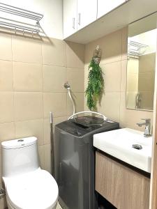 a bathroom with a toilet and a sink at Casa Abigail Shore 3 in Manila