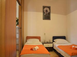 a room with two beds and a mirror at Apartment Manuela in Dubrovnik