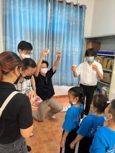 a group of people wearing face masks in a room at Nhà Khách Làng May Mắn - Village Chance in Ho Chi Minh City