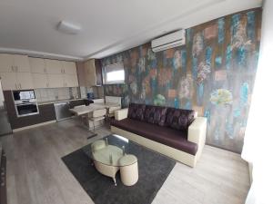 un soggiorno con divano e una cucina di Magnum apartman a Pécs
