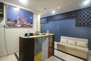 a living room with a table and a couch at Arjuna Luxury Rooms in Hyderabad