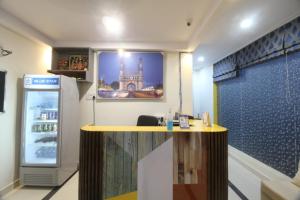 a room with a counter with a refrigerator in it at Arjuna Luxury Rooms in Hyderabad