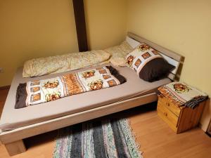 a bed with two pillows on it in a bedroom at Pizzeria Brar in Haina