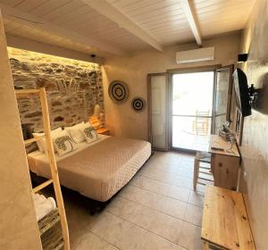 1 dormitorio con 1 cama en una habitación con ventana en Marmari Paradise Resort Hotel, en Marmari