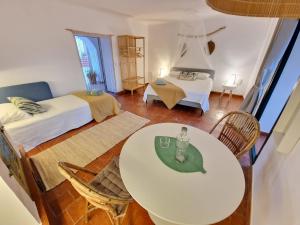 a living room with a table and a bedroom at Mongofre Agroturismo in Mahón
