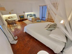 a bedroom with a bed with a mosquito net at Mongofre Agroturismo in Mahón