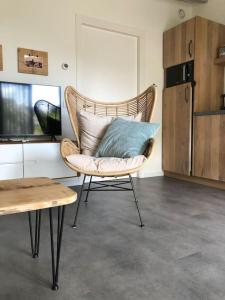 a chair with a blue pillow on it in a room at Gerrit's Guesthouse Grou in Grou