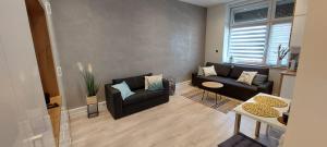 a living room with a couch and a table at Apartament w Centrum in Nysa