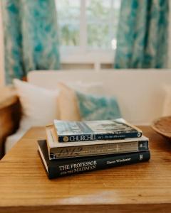 a stack of books sitting on top of a table at CoconutTree Bungalow of Villa Paraiso / Beachfront in Big Creek