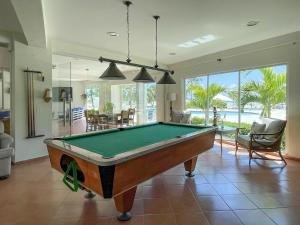 a living room with a pool table in it at New! Unique Beachfront And Pool View Apartment At Juan Dolio in Juan Dolio