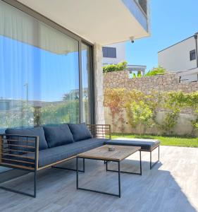 a couch and a coffee table on a patio at Vesper Suites in Dhërmi