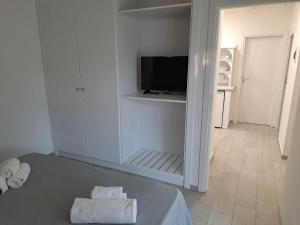 a bedroom with a bed and a tv in a room at Le Roccette Mare Beach Hotel & Restaurant in Tropea +65 photos