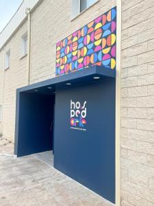 a blue door with a no dog sign in front of a building at Hotel Hospedarte, SL in Riba-Roja De Turia