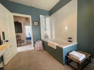 a bathroom with a large tub and a sink at Trewardale in Bodmin