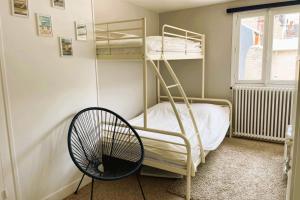 a room with two bunk beds and a fan at luminous apartment in the heart of trouville in Trouville-sur-Mer