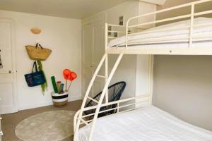 a room with a bunk bed with a ladder at luminous apartment in the heart of trouville in Trouville-sur-Mer