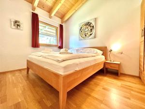 a bedroom with a large bed in a room at Schmitten Finest Apartments by All in One Apartments in Zell am See