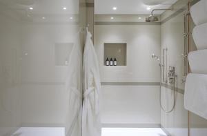 a white bathroom with a shower and a shower curtain at Henrys Townhouse Marylebone, London in London +98 photos