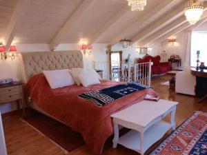 a bedroom with a large bed with a red blanket at Penelope suite 
