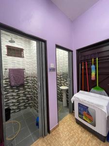 a bathroom with a walk in shower next to a door at Homestay Ummi Pendang in Pendang +3 photos
