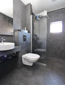a bathroom with a toilet and a sink and a shower at Beautiful house with amazing sea view. in Dalvík