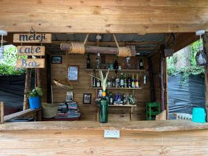 a bar inside of a wooden building with a counter at Meleji House in Arusha