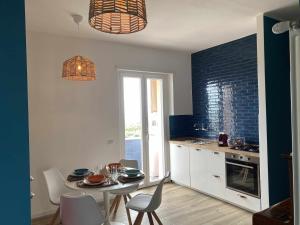 a kitchen with a table and chairs and a dining room at Casa Vacanze Nene in Minturno