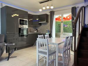a kitchen and dining room with a table and chairs at Kings Villa near Disneyland reserved only for family with kids in Saint-Germain-sur-Morin