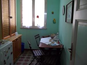 a kitchen with a table and chairs in a room at Mare e Monti in Giardini Naxos