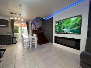 a living room with a fireplace and a tv on a wall at Kings Villa near Disneyland reserved only for family with kids in Saint-Germain-sur-Morin