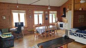 a kitchen and living room with a table and chairs at Spacious house by the Hardangerfjord 