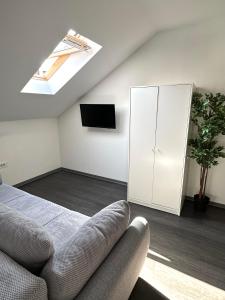 a attic bedroom with a bed and a skylight at KAPTOL Rooms in Zagreb
