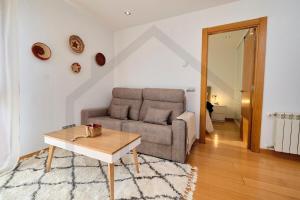 a living room with a couch and a table at Apartamento La Muralla - Gijón in Gijón +53 photos